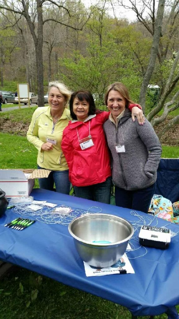 Three ladies at the registration table of the 2016 Oil Creek Classic